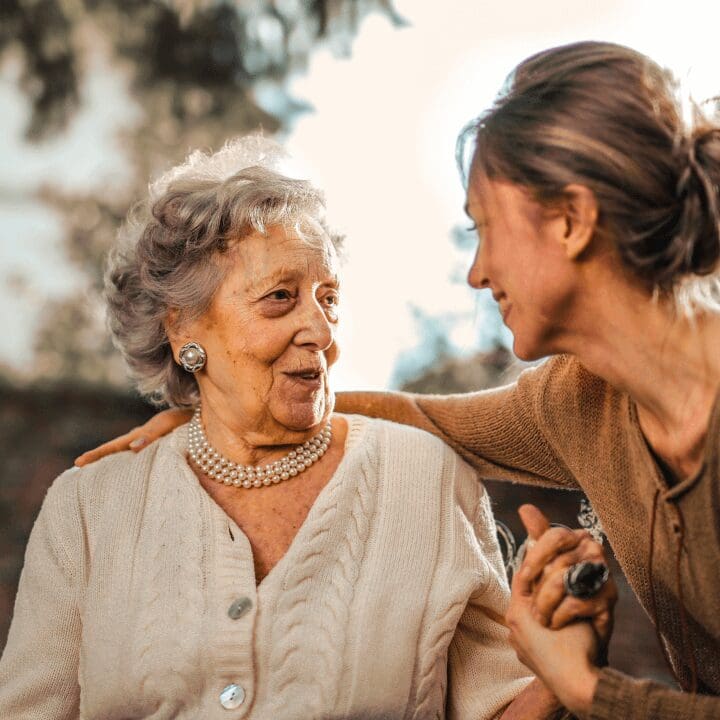 A woman and an older person smiling for the camera.
