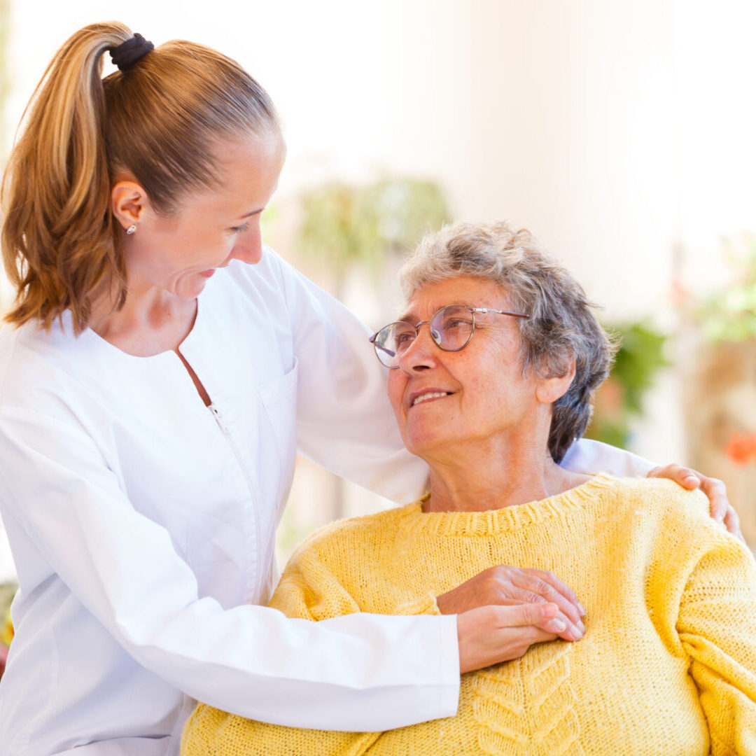 A woman is hugging an older person
